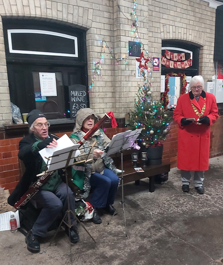 Deputy Mayor with some of the carol singers
